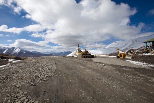 The crest of the pass is typically marked by a Chorten and fluttering prayer flags